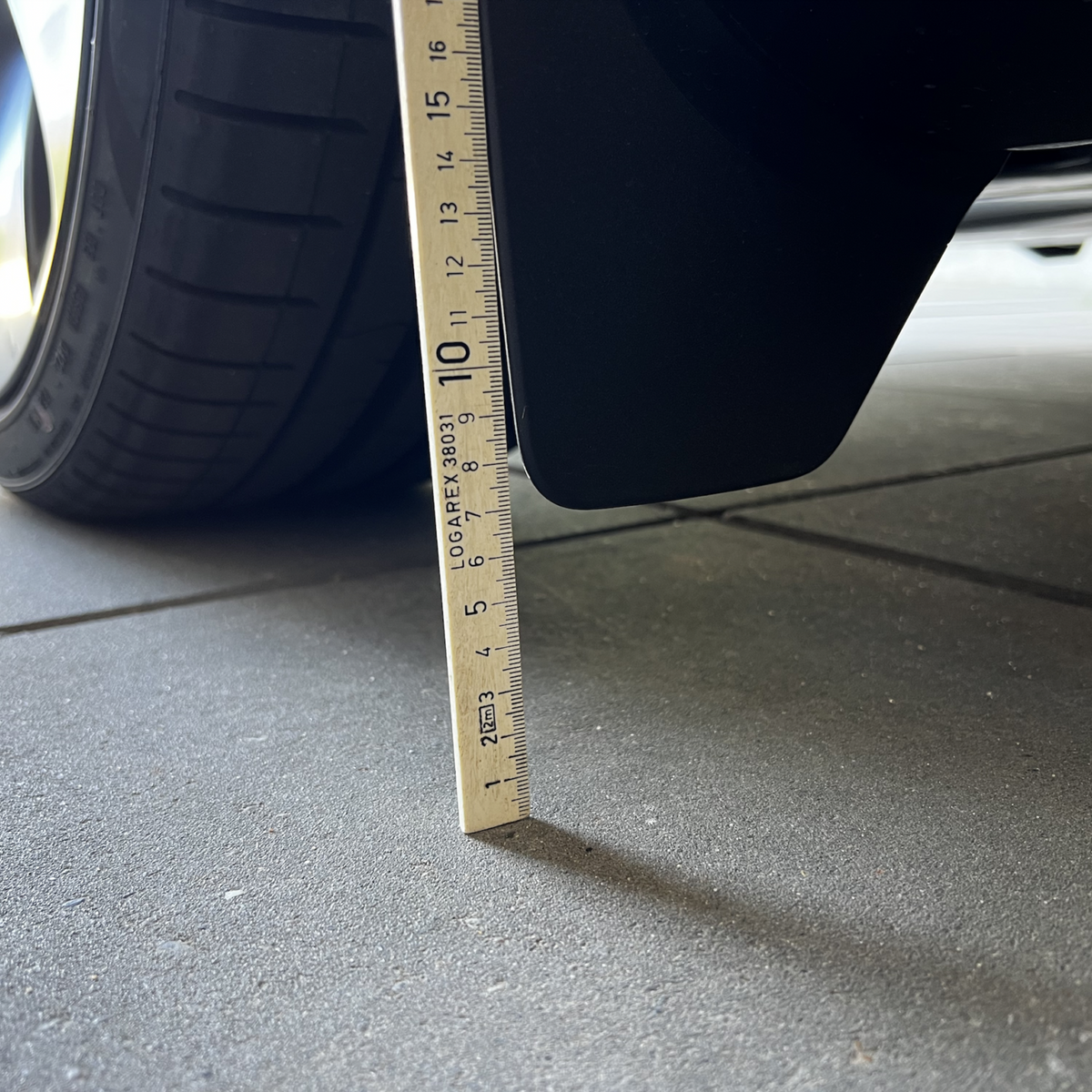 Originele spatborden op Tesla Model Y gemeten met liniaal.