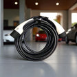 GCG MAX laadkabel Type 2 voor elektrische auto's, opgerold op een tegelvloer.