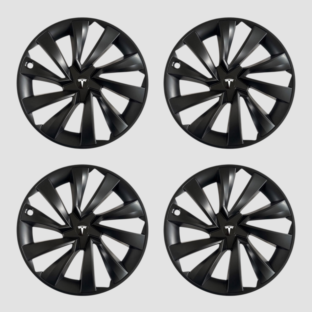 Vier zwarte MV Spiral wieldoppen met Tesla-logo voor Model Y 2025.